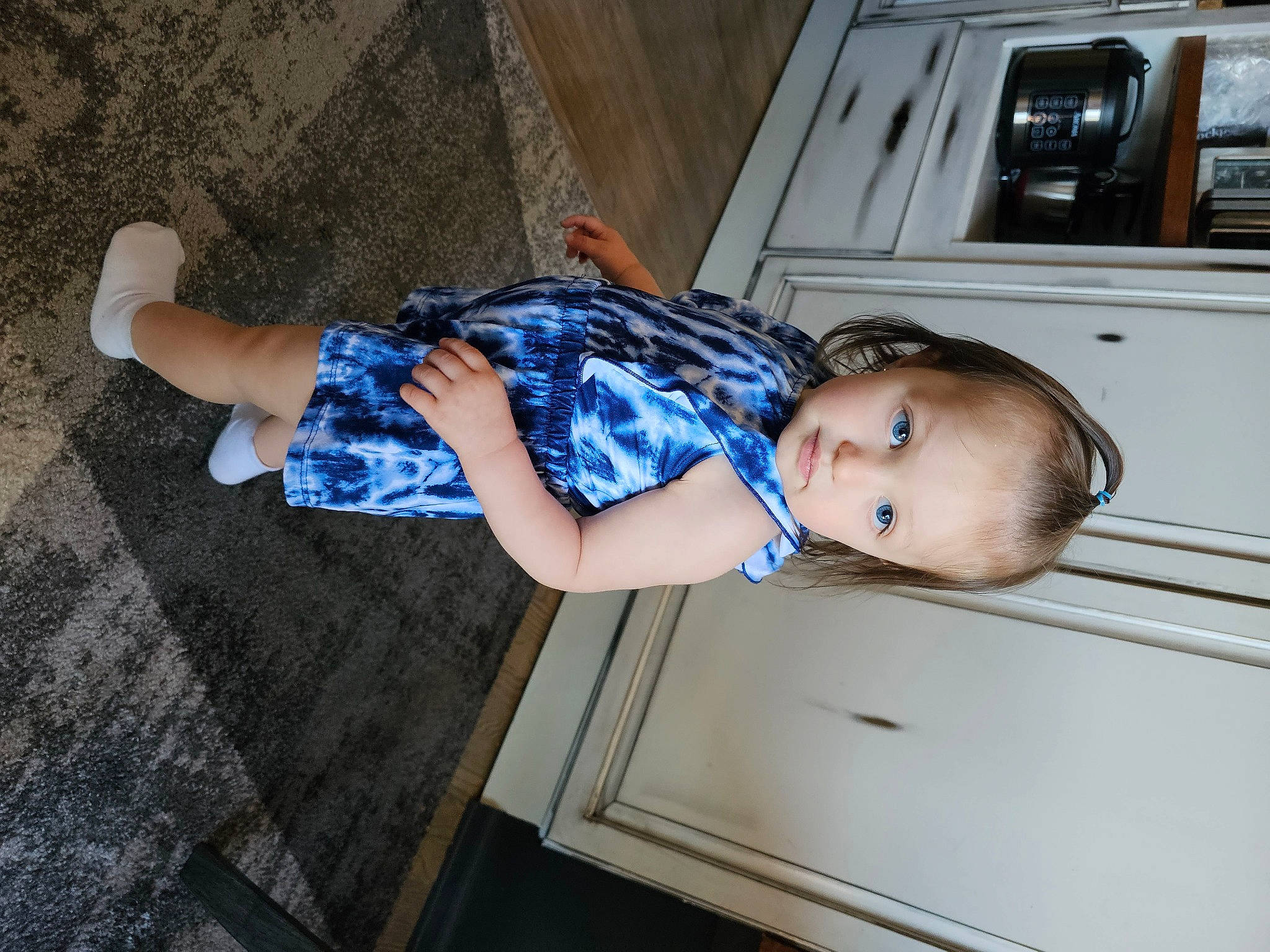 Amiya is registered to the contest to win money with this photo: arm, baby, baby_toddler_clothing, child, comfort, elbow, electric_blue, fun, gas, home_appliance, human_leg, joint, kitchen_appliance, pattern, person, sitting, sleeve, standing, t_shirt, toddler