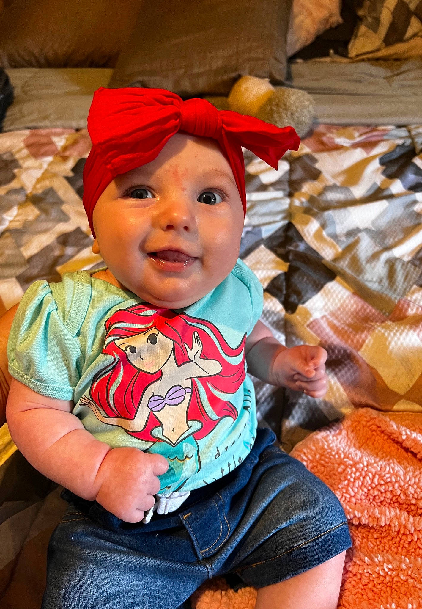 Annaliese is registered to the contest to win money with this photo: baby, baby_toddler_clothing, carmine, cheek, child, fashion_accessory, fun, happy, head, headwear, joy, leisure, mouth, orange, pattern, person, play, sitting, skin, smile