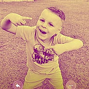 Carson joined the competition — help win amazing prizes! child, boy, outdoor, grass, playful, pose, tshirt, shorts, smiling, happy, phone_screen, text_overlay, call_interface, grass_field, casual_clothing, short_hair, young, person, fun_filter, digital_overlay