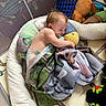 baby, sleeping, bottle, blanket, pillow, playpen, toy, stuffed_animal, connect_four, floor_mat, child, diaper, indoor, cozy, cuddle, nap, soft, comfort, peaceful, play_area
