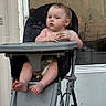 Journey is registered to the contest to win money with this photo: baby, child, high_chair, paint, face_paint, outdoor, window, door, curious, barefoot, expression, seat, plastic, foot, hand, skin, hair, infant, person, chair