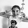 Alaïs a rejoint le concours — aidez-le/la à gagner de superbes lots ! child, girl, smiling, peace_sign, tank_top, leopard_print, cartoon_print, black_and_white, indoor, wall, decor, happy, posing, portrait, casual_clothing, youth, cute, fun, playful, hair