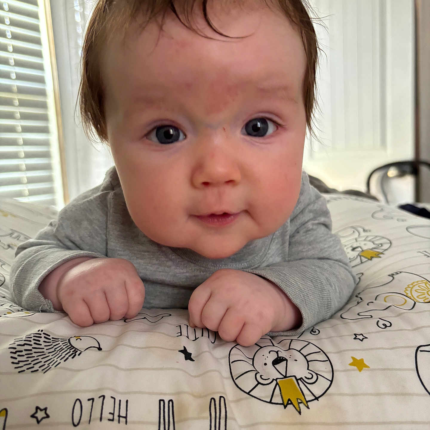 Keagan is registered to the contest to win money with this photo: baby, bedroom, blanket, child, closeup, cozy, curious, cute, expression, face, hands, home, indoor, infant, pattern, person, portrait, soft_light, toddler, young_child