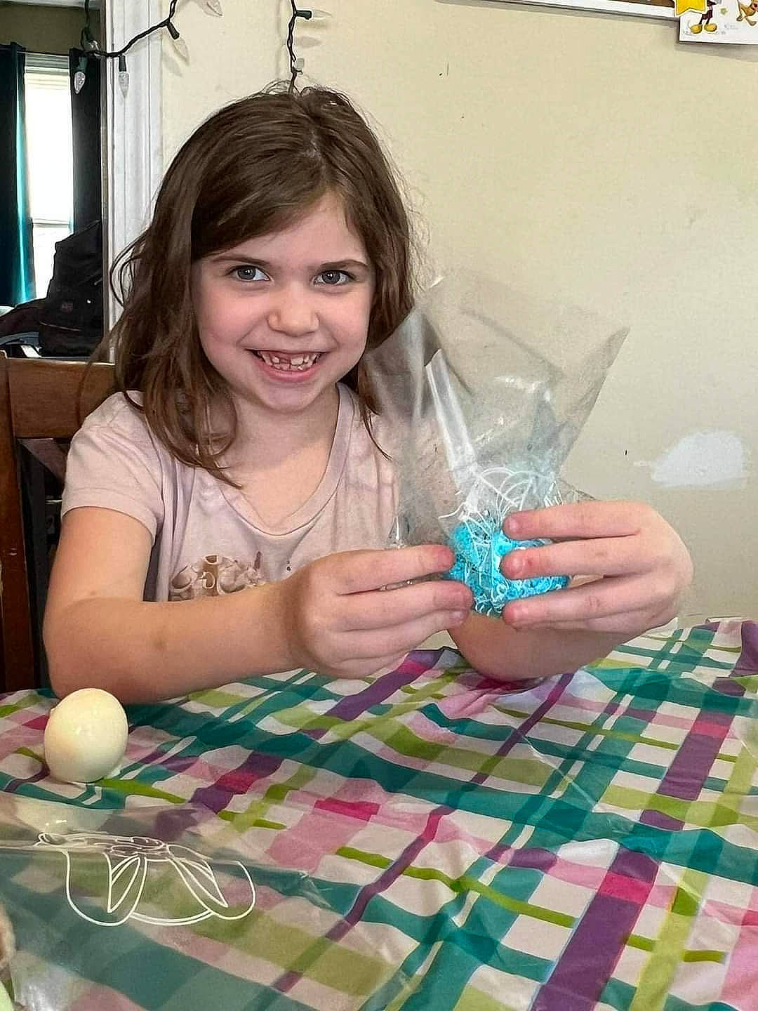 Zoey joined the competition — help win amazing prizes! chair, child, drinkware, event, flooring, fun, glass, happy, joy, leisure, pattern, person, pink, plaid, play, purple, room, smile, table, tableware