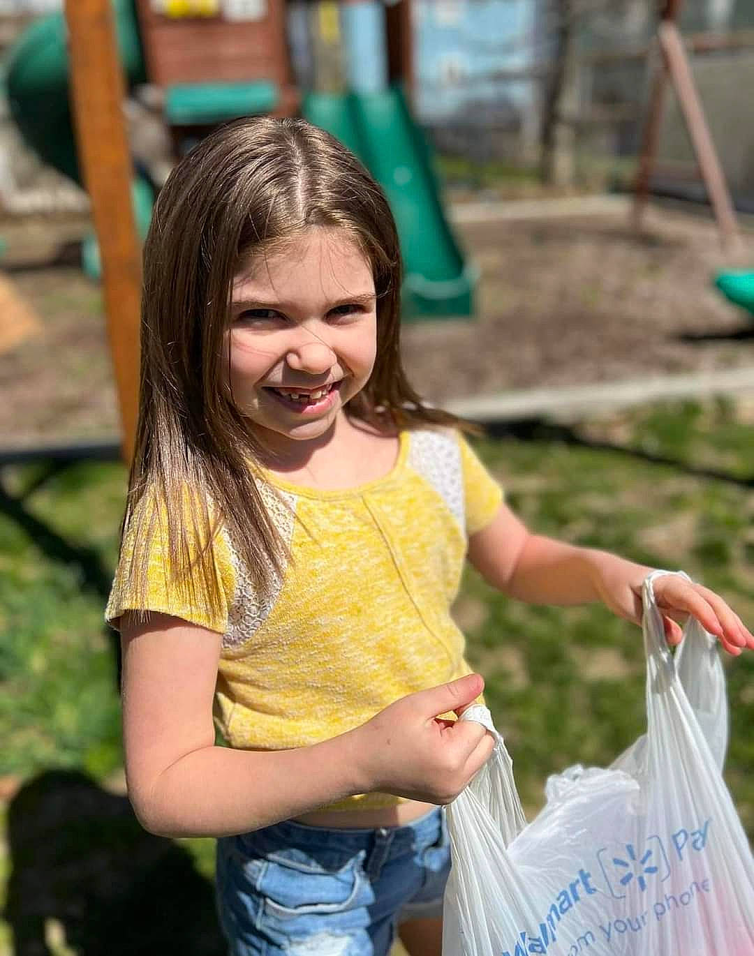 Zoey joined the competition — help win amazing prizes! blond, child, event, face, fun, grass, green, happy, joy, leisure, person, photograph, plastic_bag, playground, recreation, shorts, smile, snapshot, summer, t_shirt