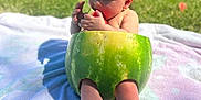 Ivy Grace is registered to the contest to win money with this photo: baby, child, watermelon, fruit, outdoor, grass, towel, summer, cute, red_bow, eating, food, nature, sunlight, picnic, skin, legs, feet, happy, playful