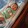 newborn, baby, hospital, bassinet, onesie, wristband, blanket, striped_blanket, infant, sleeping_area, medical, person, cute, indoor, healthcare, resting, small, face, child, newborn_baby