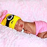 adorable, baby, bow, child, closeup, cozy, crocheted_hat, cute, hat, infant, newborn, peaceful, pink_blanket, pink_clothing, portrait, resting, skin, sleeping, soft_texture, yellow_hat