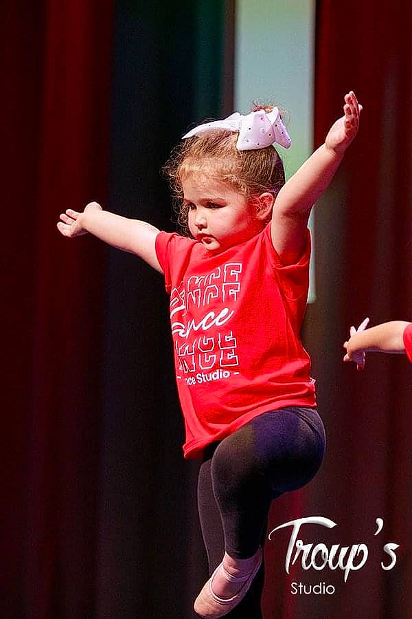 Amiyah is registered to the contest to win money with this photo: child, choreography, curtain, dancer, entertainment, event, fashion_design, flash_photography, fun, happy, human_leg, knee, leg, magenta, performance_art, performing_arts, person, pink, sportswear, t_shirt