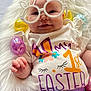 Lainey is registered to the contest to win money with this photo: accessories, baby, bodypart, clothing, costume, face, finger, glasses, happy, hat, head, homedecor, newborn, person, photography, portrait, purple, smile, t_shirt, toy