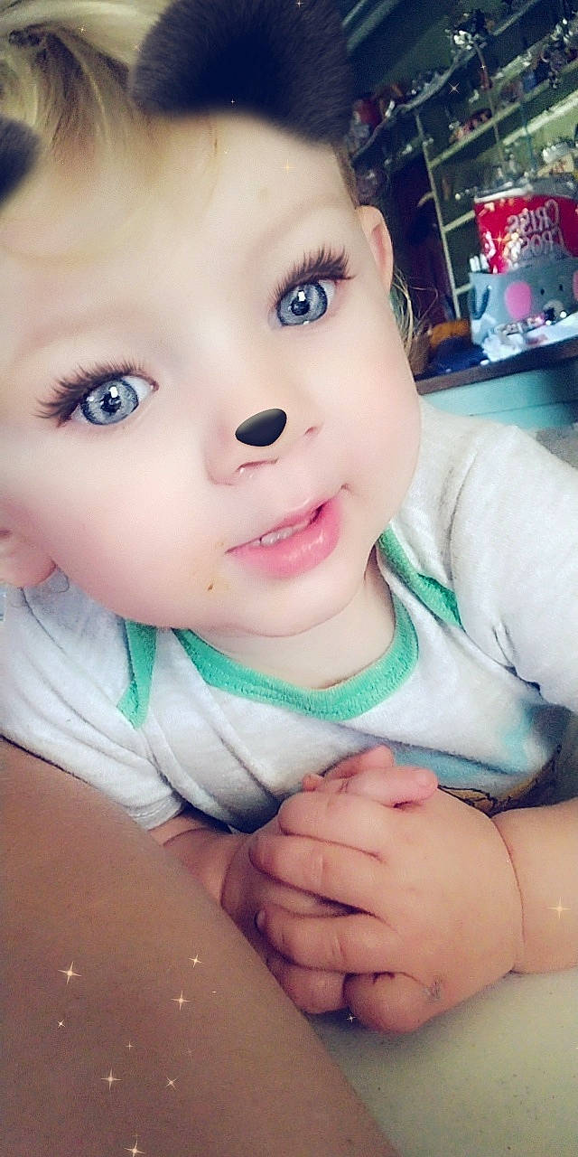 Paige is registered to the contest to win money with this photo: baby, cheek, chin, eyebrow, eyelash, finger, fun, gesture, hand, happy, human_body, iris, jaw, lip, mouth, neck, nose, person, skin, thumb