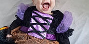Darcey joined the competition — help win amazing prizes! baby, bed, child, clothing, costume, crib, cute, fun, halloween, happy, headband, indoors, infant, joyful, orange, person, plush_toy, portrait, purple, smiling