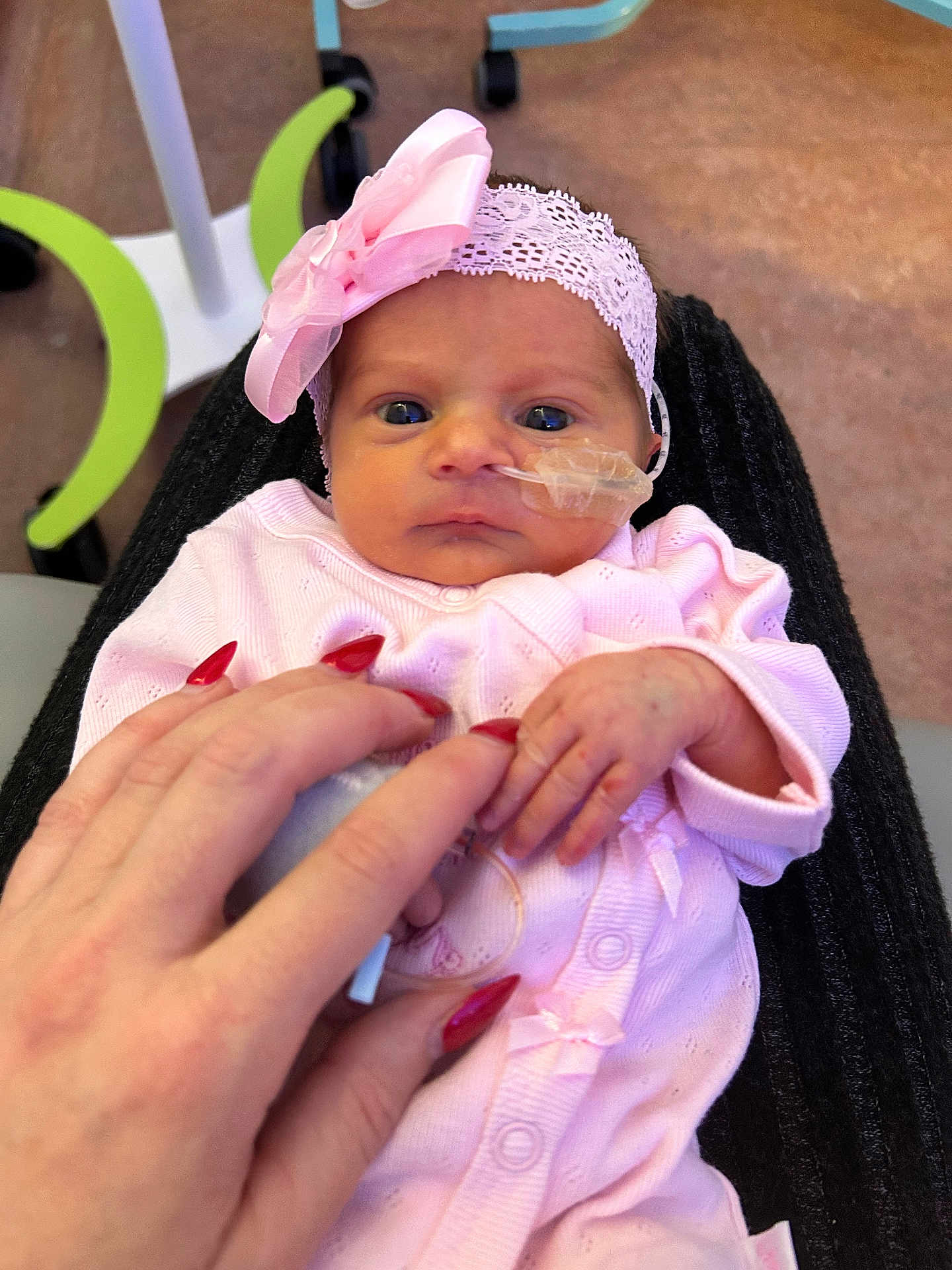 Faith joined the competition — help win amazing prizes! baby, infant, pink_clothing, headband, bow, hand, fingers, nails, hospital, medical_tube, face, eyes, person, newborn, cute, portrait, holding, skin, caring, tender
