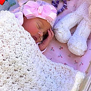 Faith joined the competition — help win amazing prizes! newborn, baby, sleeping, blanket, pink_headband, bow, soft_toys, plush, white_blanket, floral_sheet, infant, cute, peaceful, cozy, child, resting, indoors, closeup, adorable, toddler