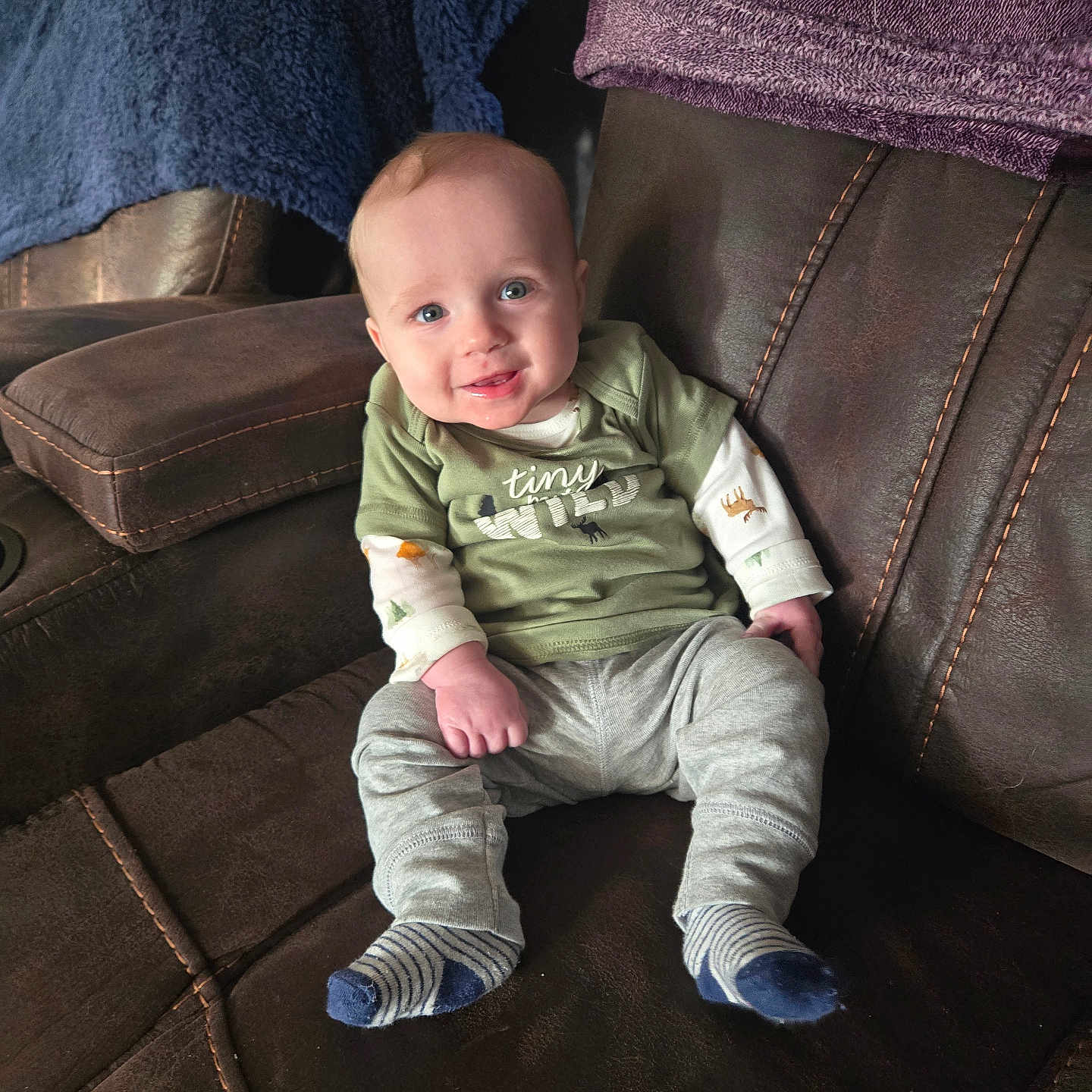 Declan is registered to the contest to win money with this photo: baby, bodypart, chair, clothing, couch, cushion, face, finger, furniture, hand, head, homedecor, hosiery, jeans, pants, person, photography, portrait, sitting, sock