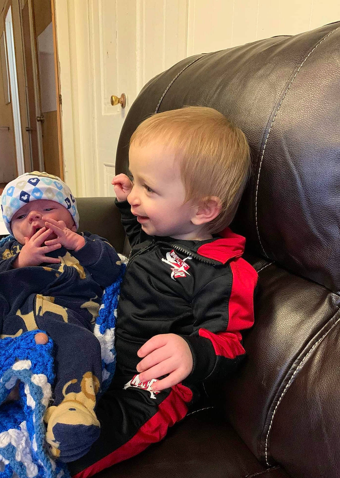 Braxton is registered to the contest to win money with this photo: baby, baby_toddler_clothing, car_seat, cheek, child, comfort, couch, curtain, event, fun, happy, head, headwear, human, human_body, iris, lap, person, sitting, skin