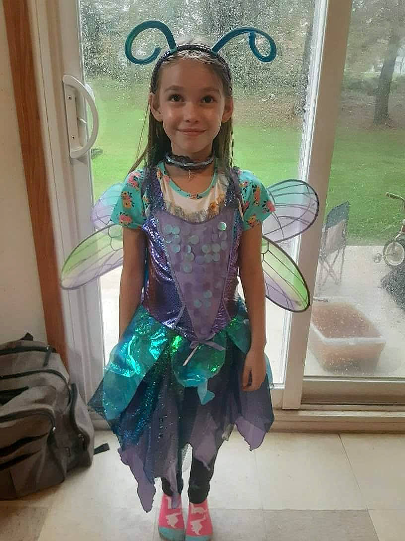 Lexi is registered to the contest to win money with this photo: baby_toddler_clothing, child, costume, event, fashion_accessory, fashion_design, formal_wear, green, happy, joy, luggage_and_bags, magenta, person, plant, plumbing_fixture, room, smile, sock, tap, toddler