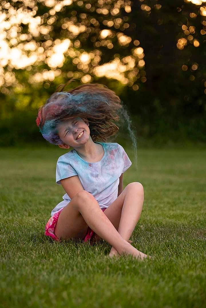 Lily is registered to the contest to win money with this photo: black_hair, botany, eye, flash_photography, grass, grassland, happy, human_body, joy, leg, leisure, people_in_nature, person, plant, shoe, shorts, smile, sunlight, thigh, tints_and_shades