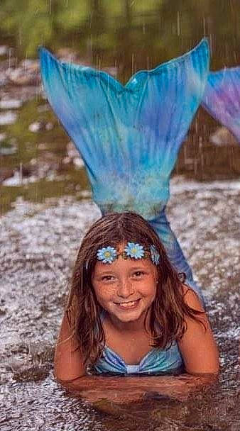 Lily is registered to the contest to win money with this photo: electric_blue, fashion_accessory, feather, fun, grass, green, happy, headpiece, headwear, iris, joy, leisure, light, natural_environment, natural_material, nature, people, people_in_nature, person, photograph