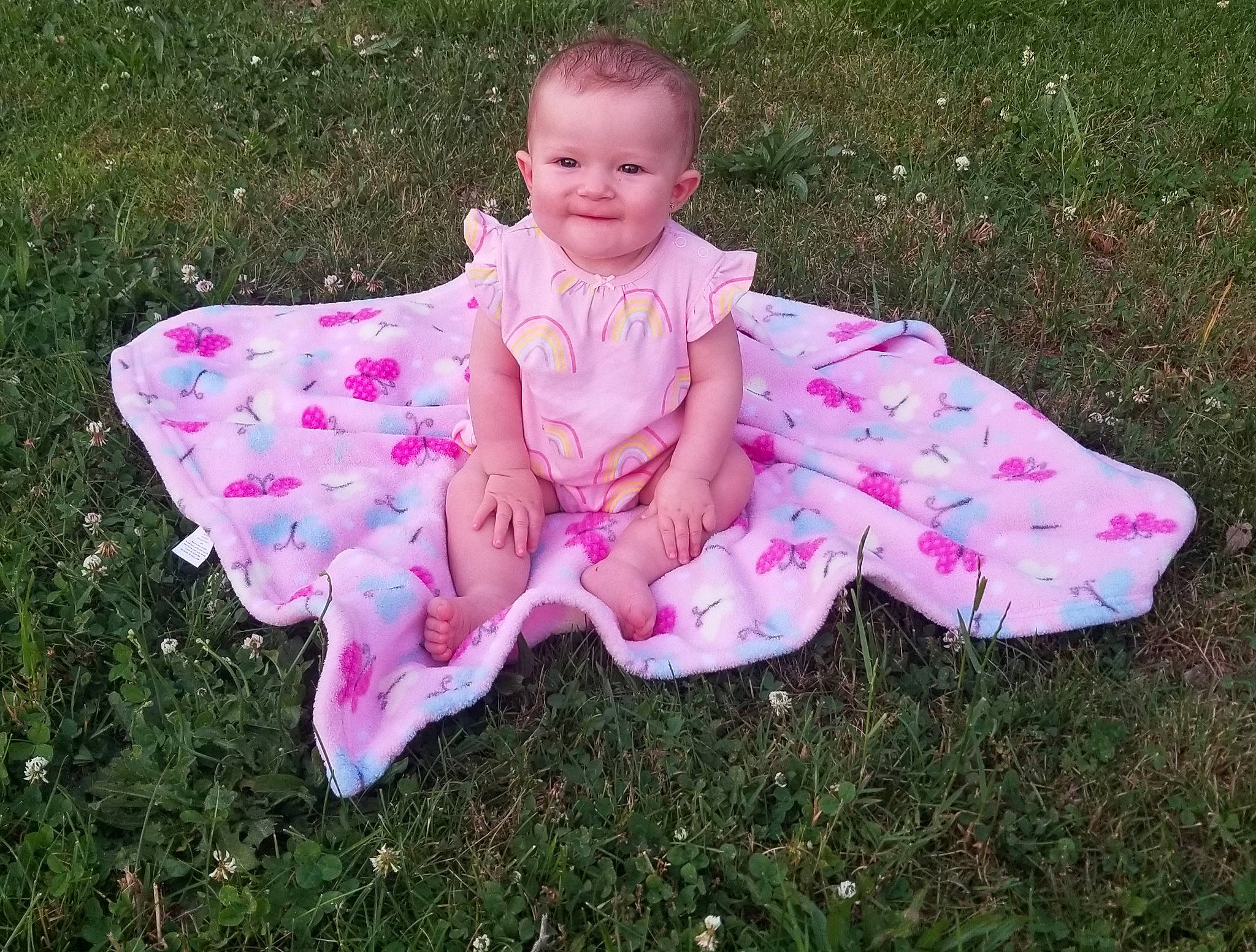 Kynslee is registered to the contest to win money with this photo: baby, baby_products, baby_toddler_clothing, child, costume, dress, grass, joy, leaf, pattern, person, petal, pink, plant, play, product, sitting, textile, toddler