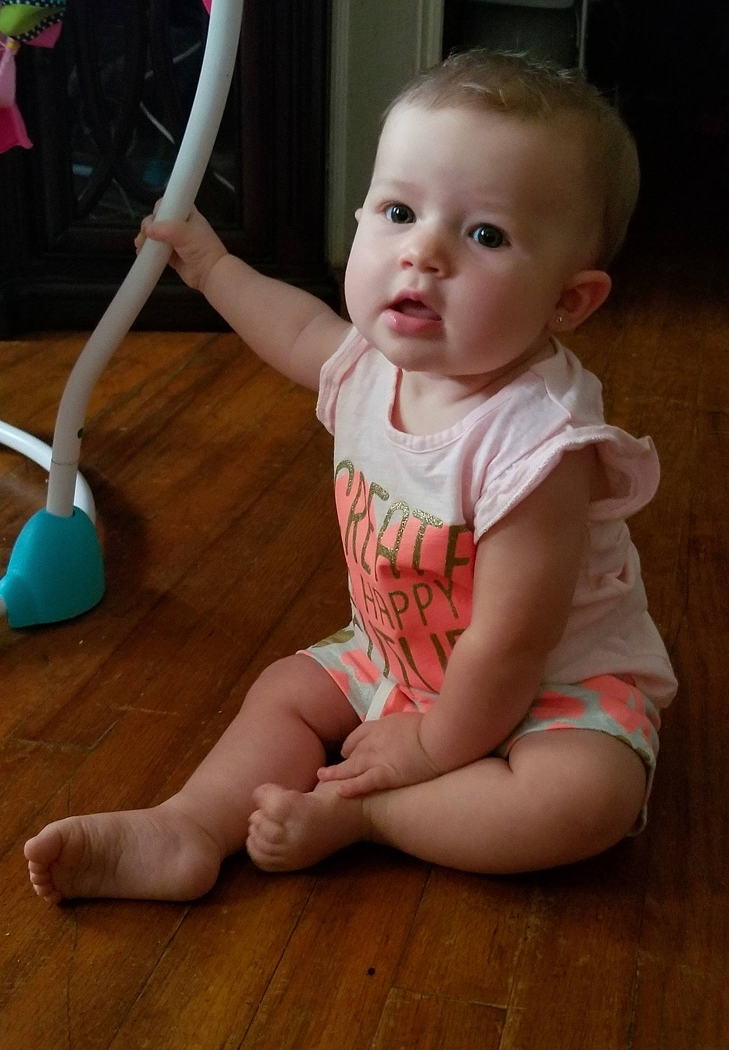 Kynslee is registered to the contest to win money with this photo: baby, baby_toddler_clothing, cheek, child, finger, floor, flooring, leg, person, play, shoe, sitting, skin, smile, standing, toddler, wood