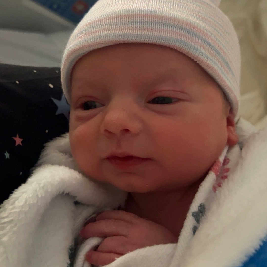 Draven joined the competition — help win amazing prizes! architecture, baby, beanie, blanket, bonnet, building, cap, clothing, face, glove, hat, head, hospital, newborn, person, photography, portrait, quilt, sleeping, towel