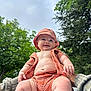 Vinny is registered to the contest to win money with this photo: baby, child, smiling, outdoor, trees, sky, hat, clothing, person, cute, happy, nature, greenery, infant, summer, portrait, skin, baby_clothes, joy, holding