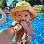 baby, child, yellow_hat, plush_toy, teddy_bear, pool, water, sunlight, outdoor, summer, smile, happy, cute, diaper, hand, face, blue, sky, trees, fence