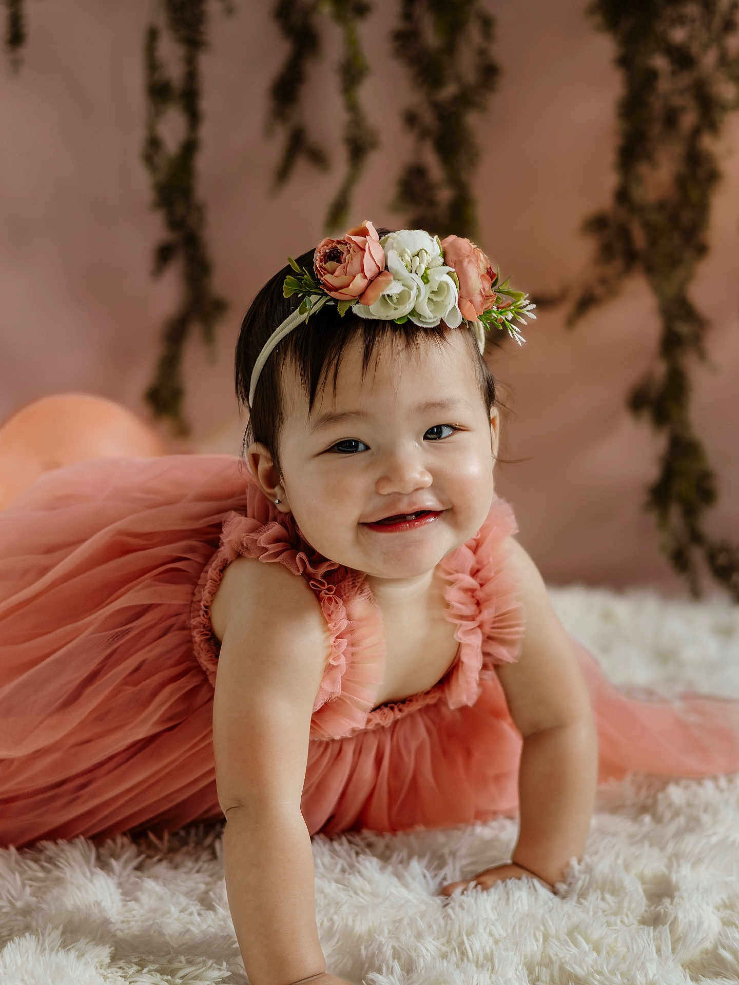 Stella is registered to the contest to win money with this photo: baby, child, dress, flower_crown, headband, smile, cute, portrait, indoor, fluffy_rug, pink, child_crawling, happy, young, person, toddler, skin, hair, face, background