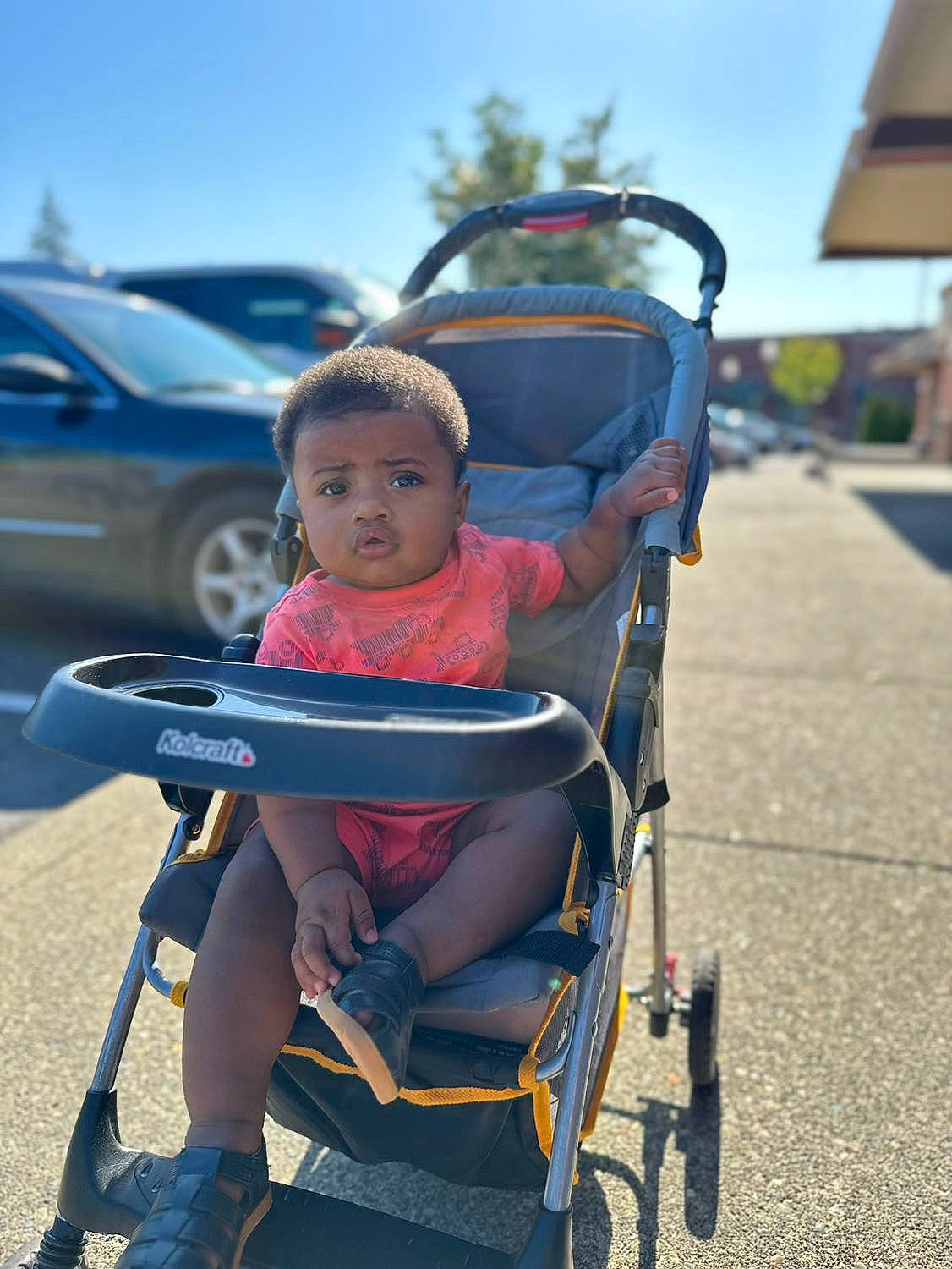 Kyrie is registered to the contest to win money with this photo: auto_part, automotive_tire, baby_carriage, baby_products, bicycle_accessory, car, child, electric_blue, eye, fun, leisure, motor_vehicle, person, recreation, sitting, sky, tire, toddler, travel, vehicle