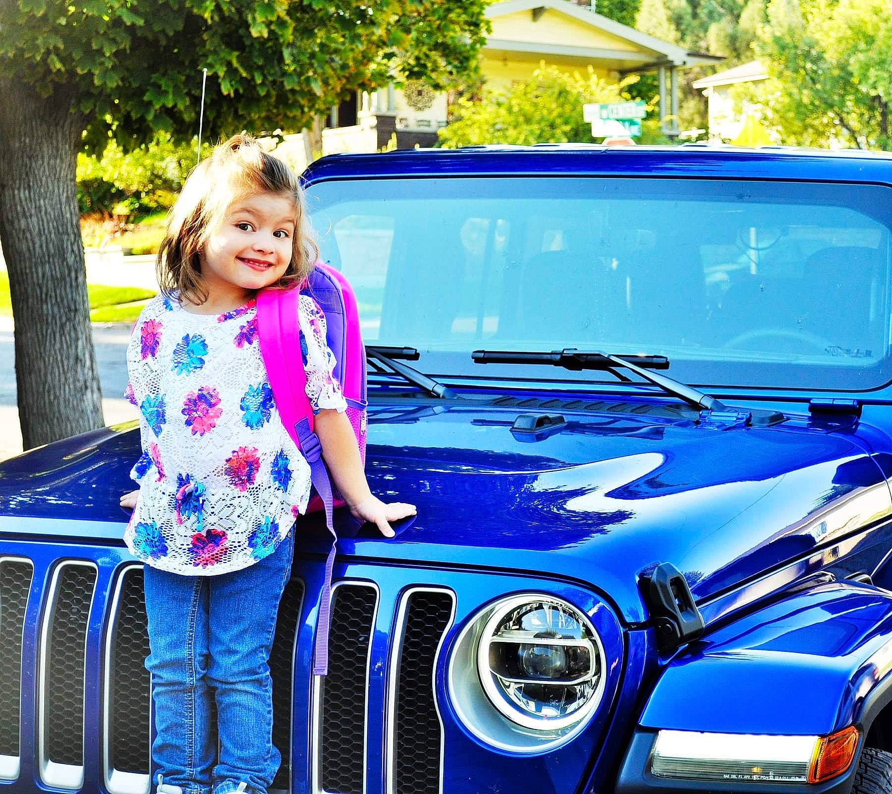 Emerald is registered to the contest to win money with this photo: automotive_design, automotive_lighting, automotive_window_part, blue, bumper, car, family_car, glass, grille, headlamp, hood, jeep, jeep_wrangler, joy, land_vehicle, motor_vehicle, person, plant, tree, vacation