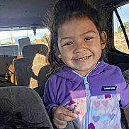 Angelica joined the competition — help win amazing prizes! child, smiling, purple_jacket, heart_pattern, car_interior, seat, sunlight, shadow, young_girl, casual_clothing, happy, portrait, daylight, window, hair, person, childhood, cute, indoor, seated