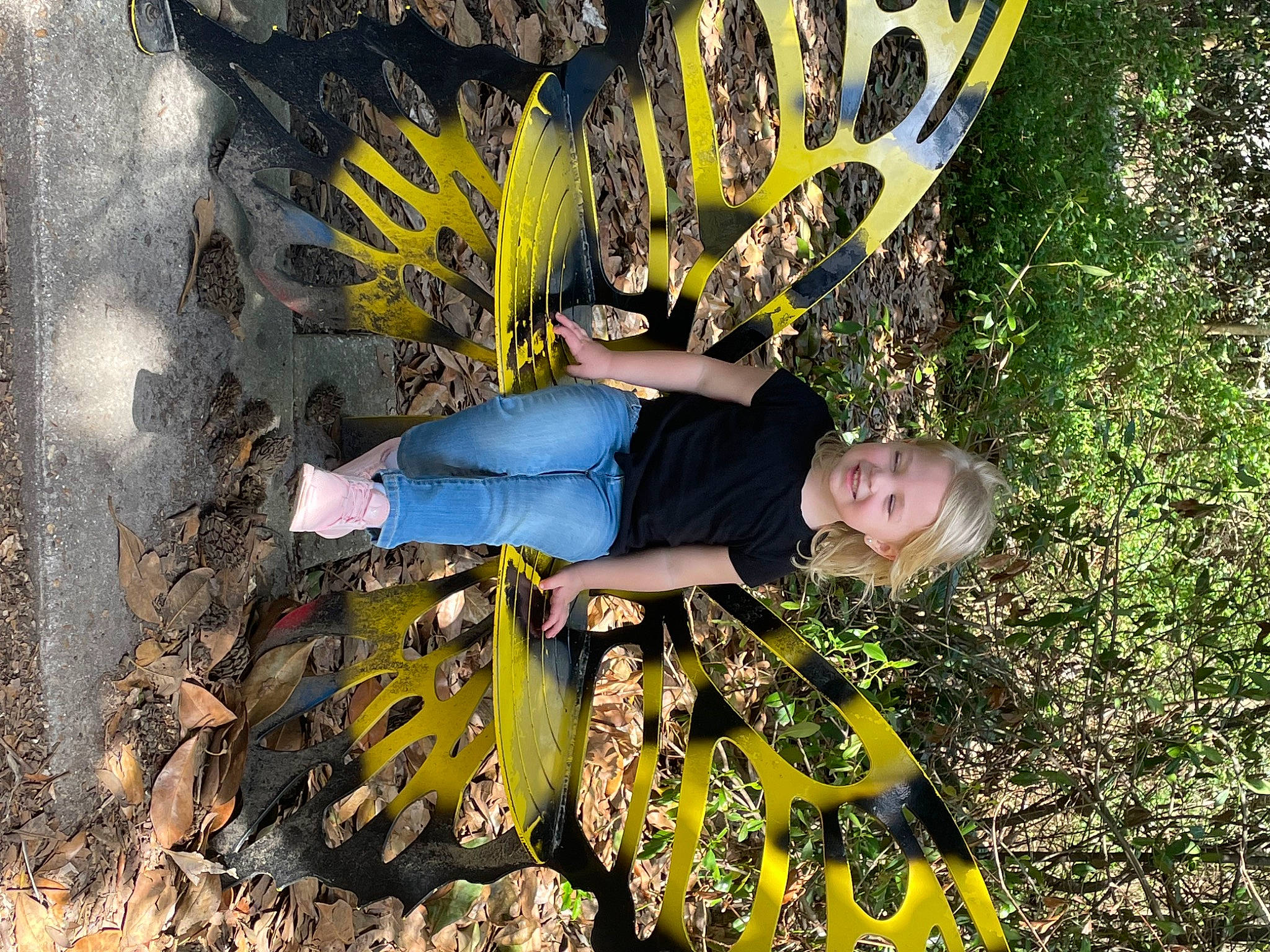 Mckenna is registered to the contest to win money with this photo: boot, fun, grass, joy, leg, leisure, pattern, people_in_nature, person, plant, recreation, smile, soil, t_shirt, thigh, tree, wood, woody_plant
