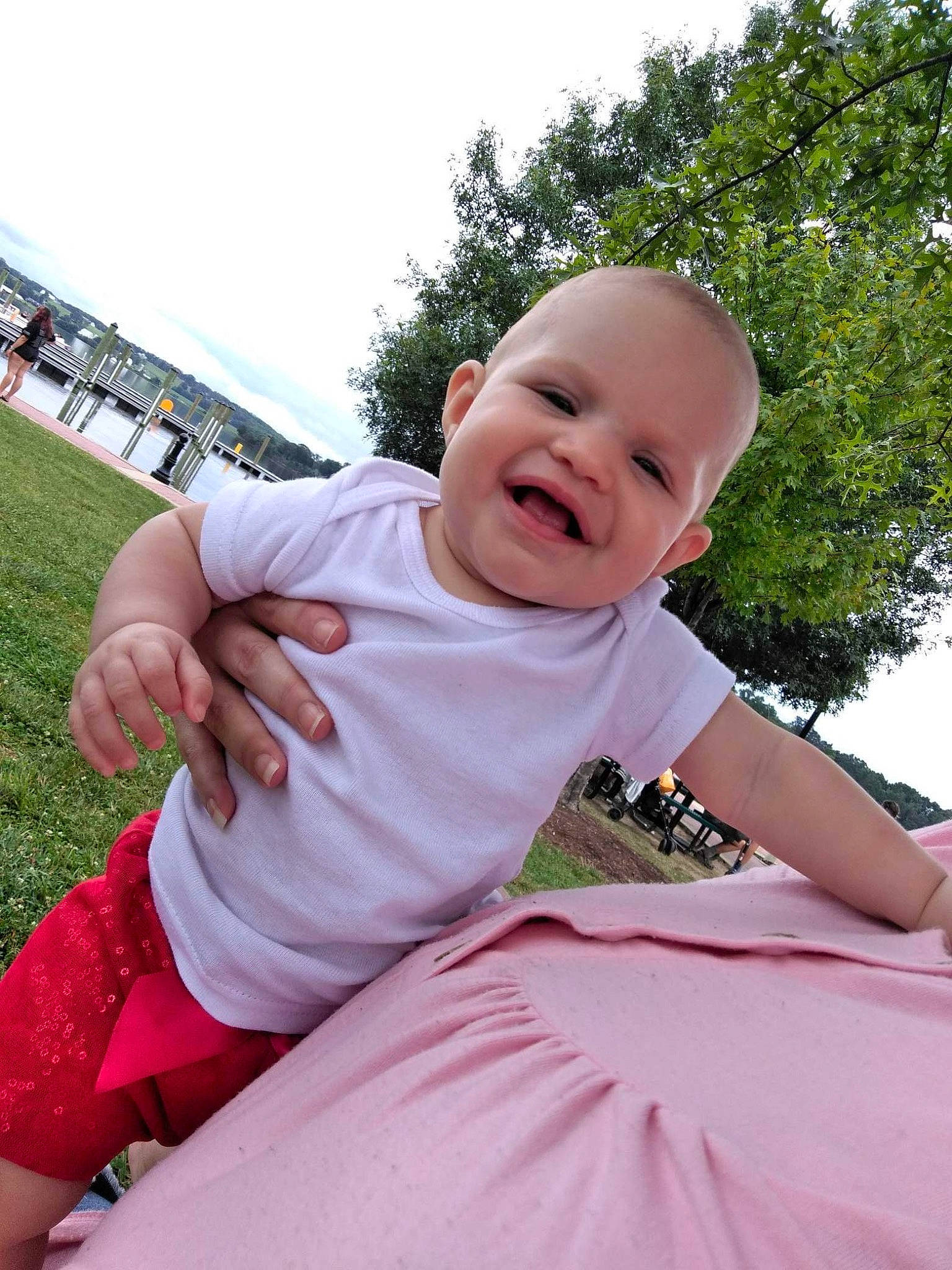 Leilani joined the competition — help win amazing prizes! baby, baby_laughing, baby_toddler_clothing, child, facial_expression, finger, fun, grass, happy, joy, leisure, magenta, person, pink, plant, shorts, sitting, sky, sleeve, smile