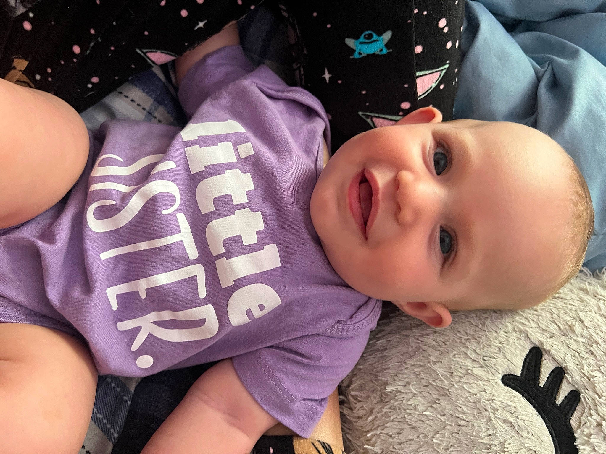 Leilani is registered to the contest to win money with this photo: baby, baby_toddler_clothing, black, cheek, child, cool, face, finger, happy, human_body, joy, lip, mouth, person, pink, purple, shorts, skin, sleeve, smile