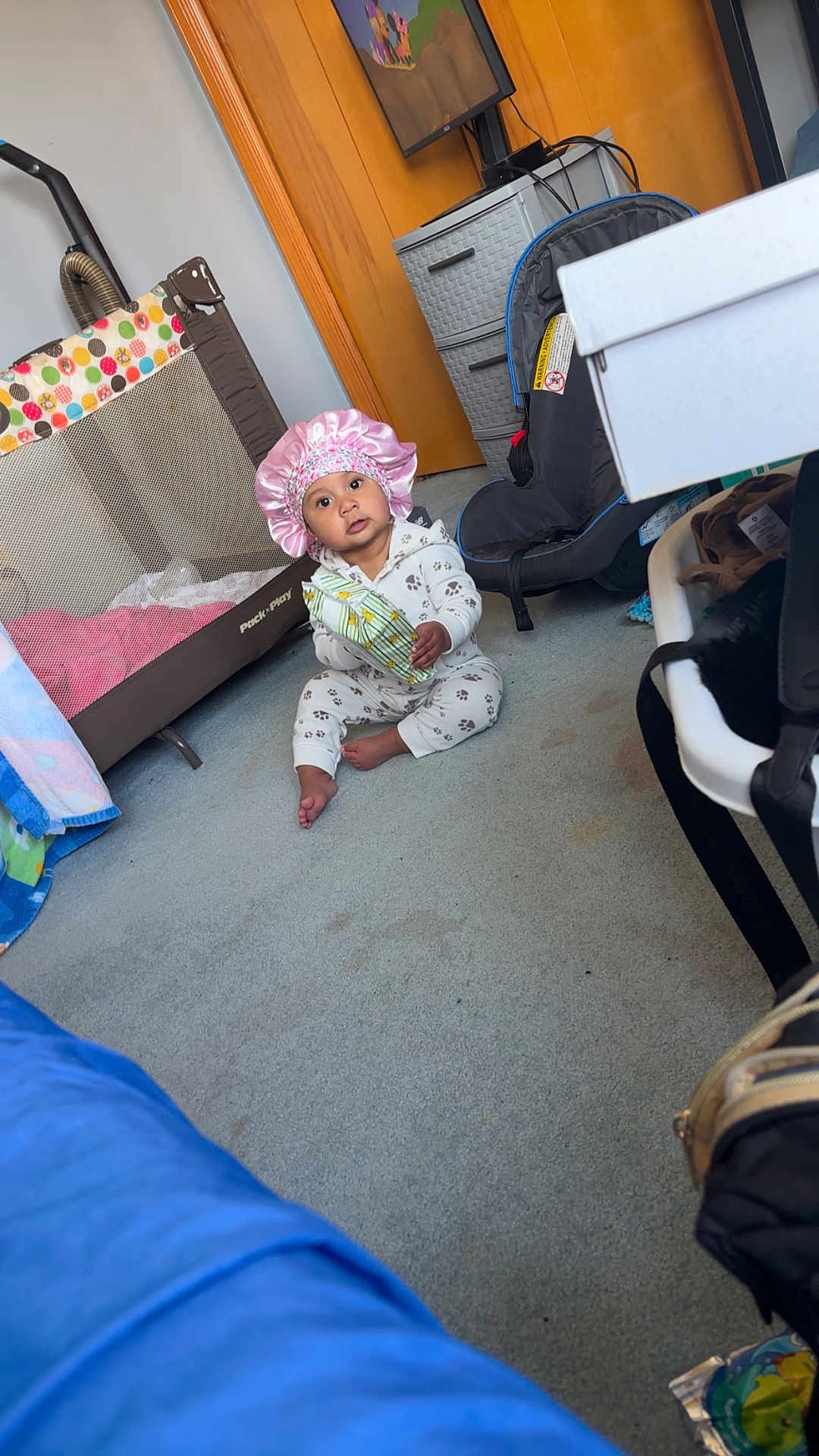 Emmah joined the competition — help win amazing prizes! baby, child, indoor, carpet, playpen, car_seat, pajamas, bonnet, snack, floor, door, drawer, furniture, toy, room, person, sitting, holding, cute, infant