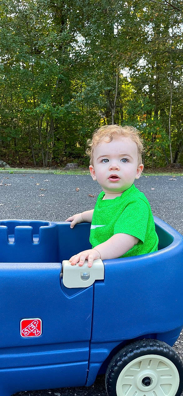 Jase is registered to the contest to win money with this photo: automotive_exterior, baby, baby_toddler_clothing, child, electric_blue, fun, grass, happy, leisure, motor_vehicle, people_in_nature, person, plant, recreation, smile, t_shirt, toddler, tree, vehicle, vehicle_door