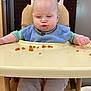 baby, child, high_chair, blue_bib, food, orange_food, face, cheeks, funny_face, table, tray, clothing, sitting, indoor, wooden_chair, expression, meal_time, cute, person, infant