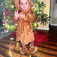 Jonathan joined the competition — help win amazing prizes! toddler, child, christmas_tree, holiday, festive_lights, wooden_floor, reindeer_costume, slippers, indoor, home, decorations, cute, seasonal, warm_clothing, person, standing, christmas_decor, holiday_spirit, festivity, curious