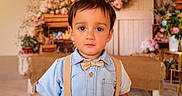 Jonathan joined the competition — help win amazing prizes! child, boy, portrait, face, clothing, bow_tie, suspenders, shirt, indoors, decor, flowers, wooden_crates, background, cute, young, person, expression, colorful, warm, casual