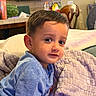 Jonathan joined the competition — help win amazing prizes! child, toddler, blue_shirt, blanket, indoor, couch, face, portrait, curious, young_child, person, home, furniture, cozy, expression, hair, seated, soft_texture, smile, relaxed