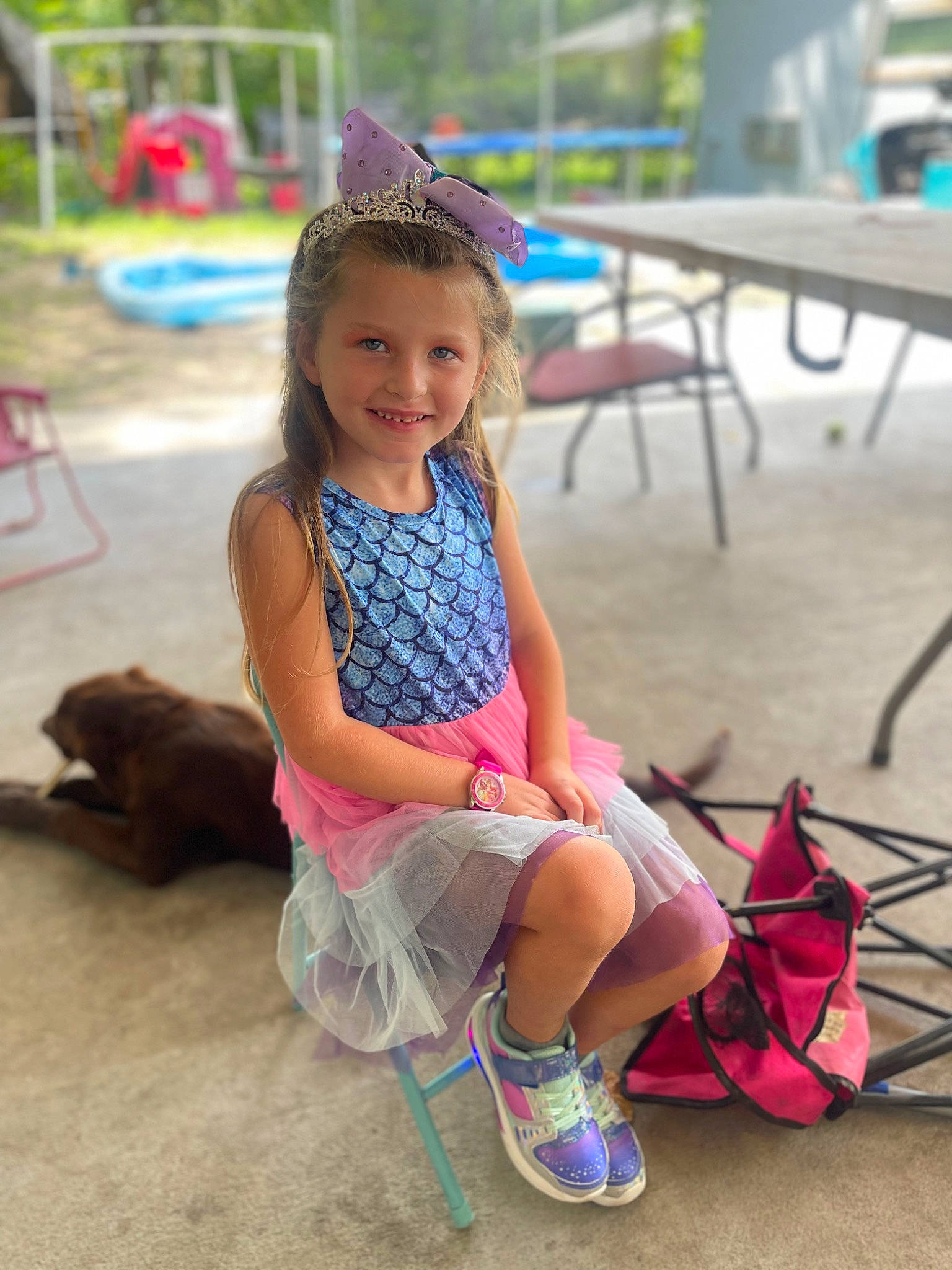 Addilynn is registered to the contest to win money with this photo: child, event, fun, grass, hair, hairstyle, happy, joy, leg, leisure, magenta, person, pink, recreation, sand, sandal, shorts, sitting, skin, smile
