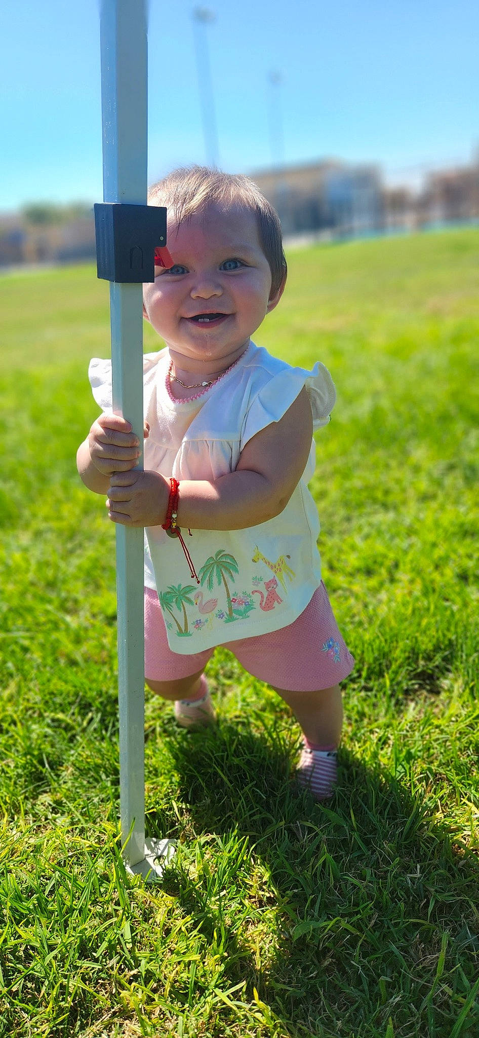 Evalina joined the competition — help win amazing prizes! baby_toddler_clothing, child, eye, face, finger, fun, grass, grassland, green, hand, happy, joy, leisure, meadow, people_in_nature, person, plant, recreation, shorts, smile