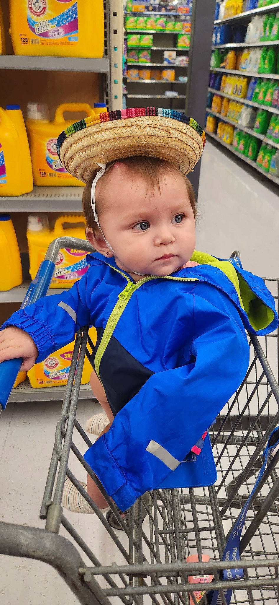 Evalina is registered to the contest to win money with this photo: baby, baby_products, baby_toddler_clothing, cap, child, city, electric_blue, event, fun, hat, leisure, person, personal_protective_equipment, product, retail, shelf, shopping, sitting, standing, toddler