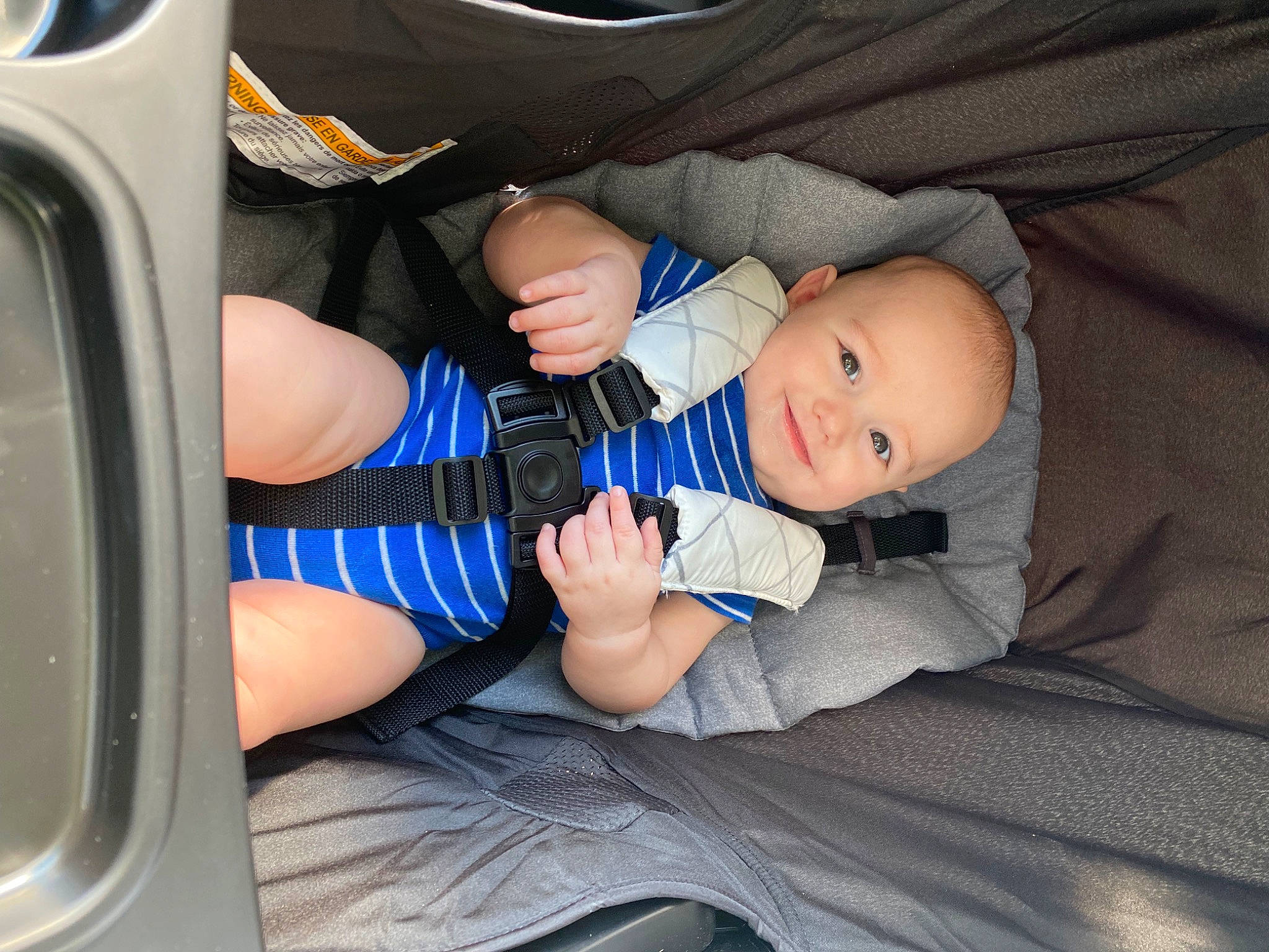 Waylen is registered to the contest to win money with this photo: auto_part, automotive_design, automotive_exterior, automotive_tire, baby, baby_in_car_seat, baby_toddler_clothing, car_seat, child, comfort, electric_blue, family_car, human_leg, joy, leg, motor_vehicle, person, product, smile, thigh