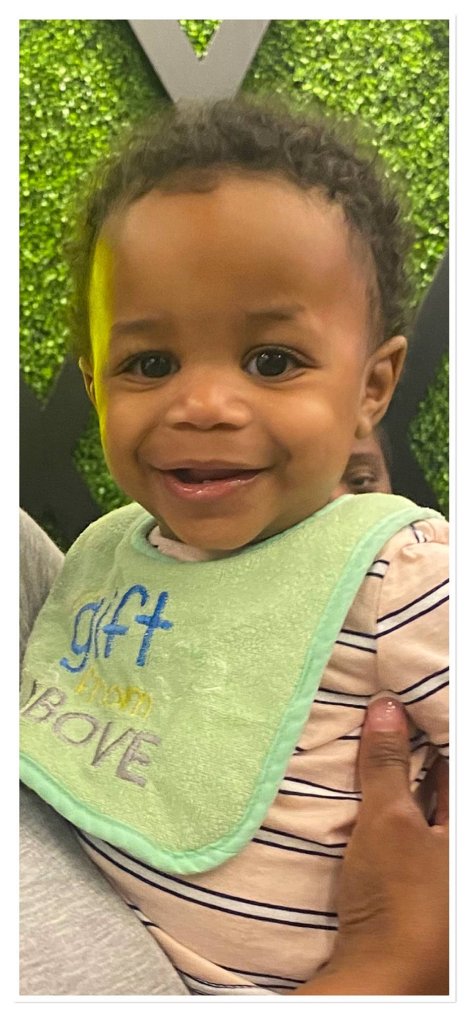 Brian is registered to the contest to win money with this photo: baby, baby_toddler_clothing, cheek, child, dress, facial_expression, grass, hair, happy, head, joy, lip, neck, nose, person, plant, skin, sleeve, smile, t_shirt