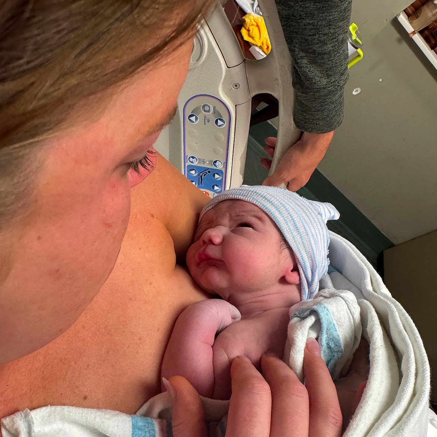 Brody is registered to the contest to win money with this photo: newborn, baby, mother, hospital, blanket, hat, skin, hand, person, bed, love, care, family, intimate, hospital_room, human, closeup, newborn_baby, parent, caring