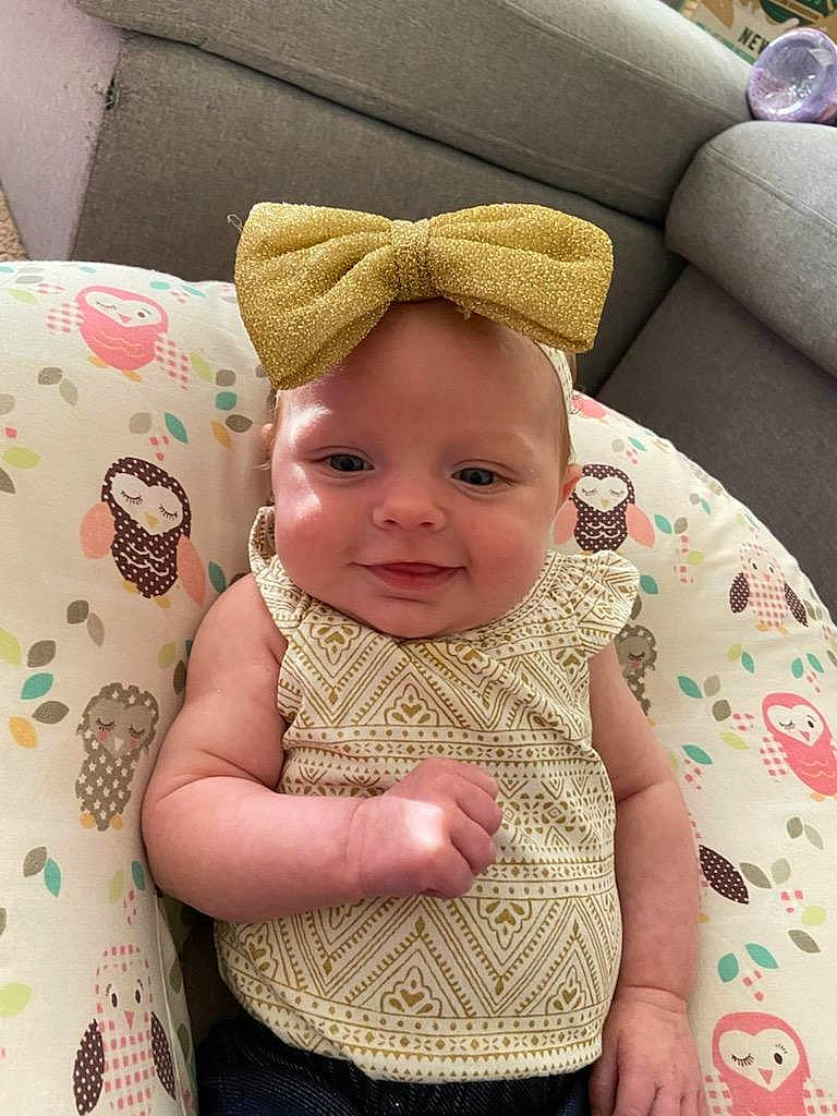 Emberlee is registered to the contest to win money with this photo: baby, baby_toddler_clothing, cap, cheek, child, comfort, couch, face, happy, headgear, jewellery, joy, linens, person, product, skin, sleeve, smile, textile, toddler