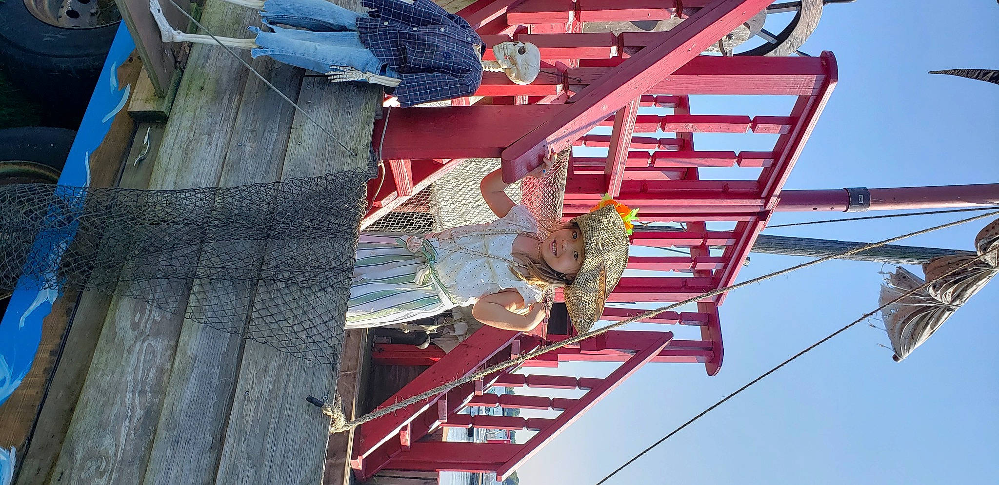 Danielle is registered to the contest to win money with this photo: composite_material, elbow, electrical_supply, electricity, engineering, facade, fun, headwear, joy, leisure, metal, outdoor_shoe, person, pole, public_utility, recreation, red, sky, stairs, t_shirt