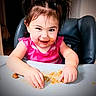 toddler, child, messy, food, beans, highchair, pigtails, pink_shirt, happy, smiling, face, hands, indoor, meal_time, cute, playful, expression, young_child, portrait, table